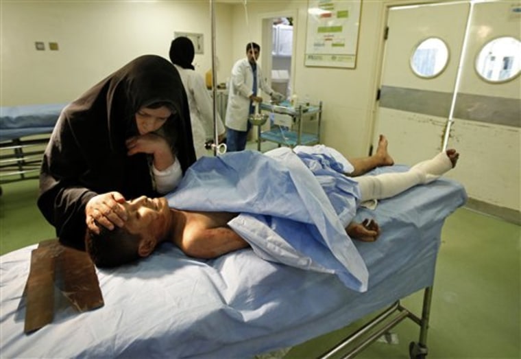 A woman comforts her son in a hospital after he was injured in a bombing in Baghdad on Wednesday. 